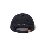 the back of a black unstructured cap with "kismet olfactive" mbroidered in white over the arch