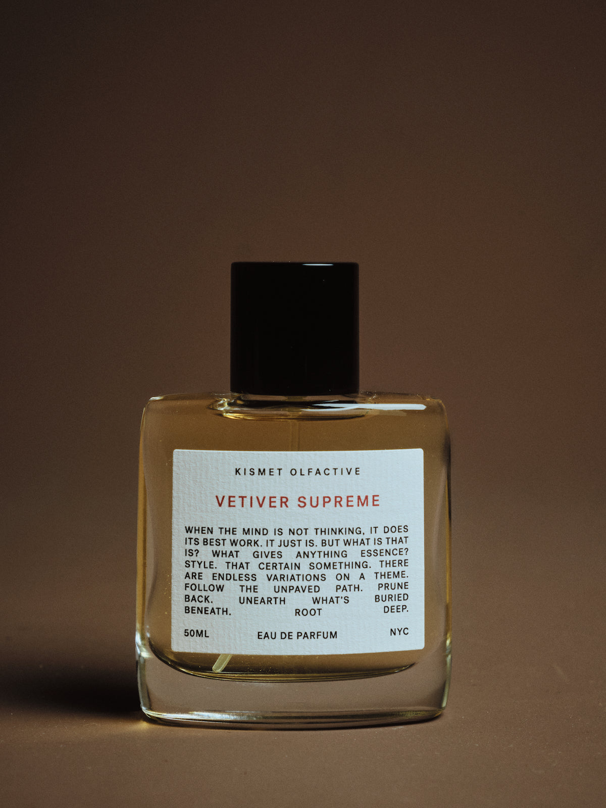 Kismet Olfactive Vetiver Supreme eau de parfum bottle on a brown background