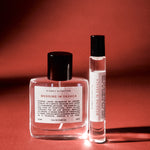 Two perfume bottles labeled 'Wedding in Oaxaca' on a red background